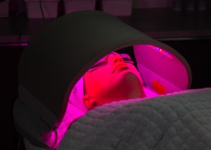 client undergoing dermalux LED treatment