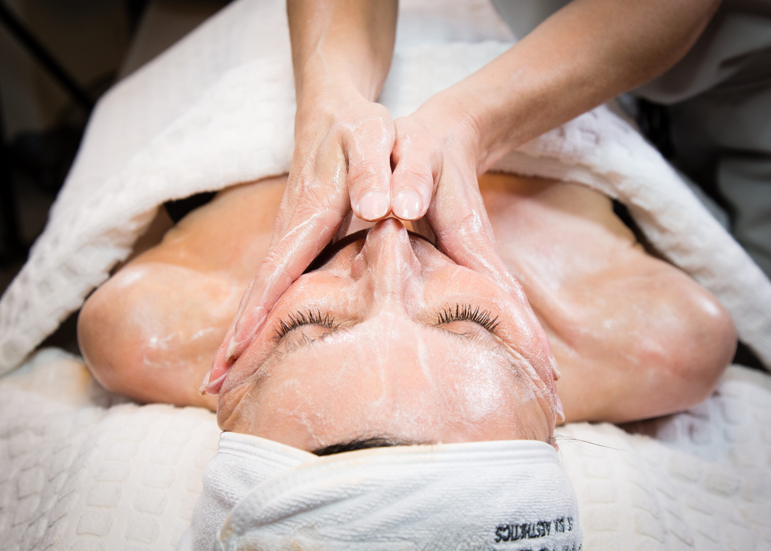 WOMAN ENJOYING FACIAL